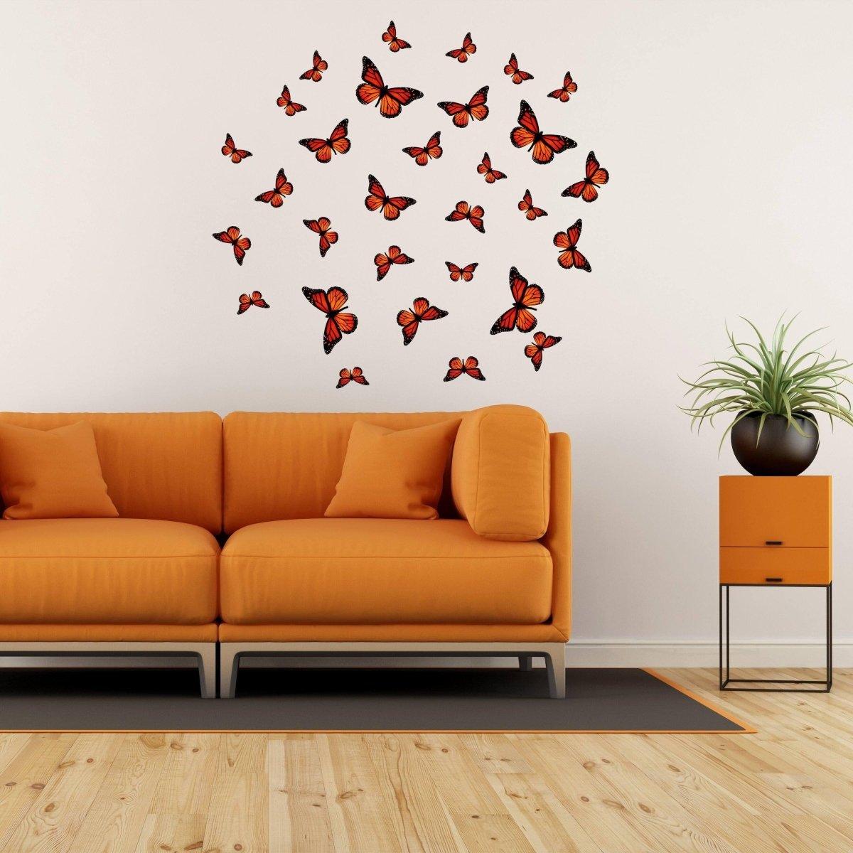 Beautiful butterfly wall decor stickers arranged above a cozy orange couch, adding a magical touch to the living room.