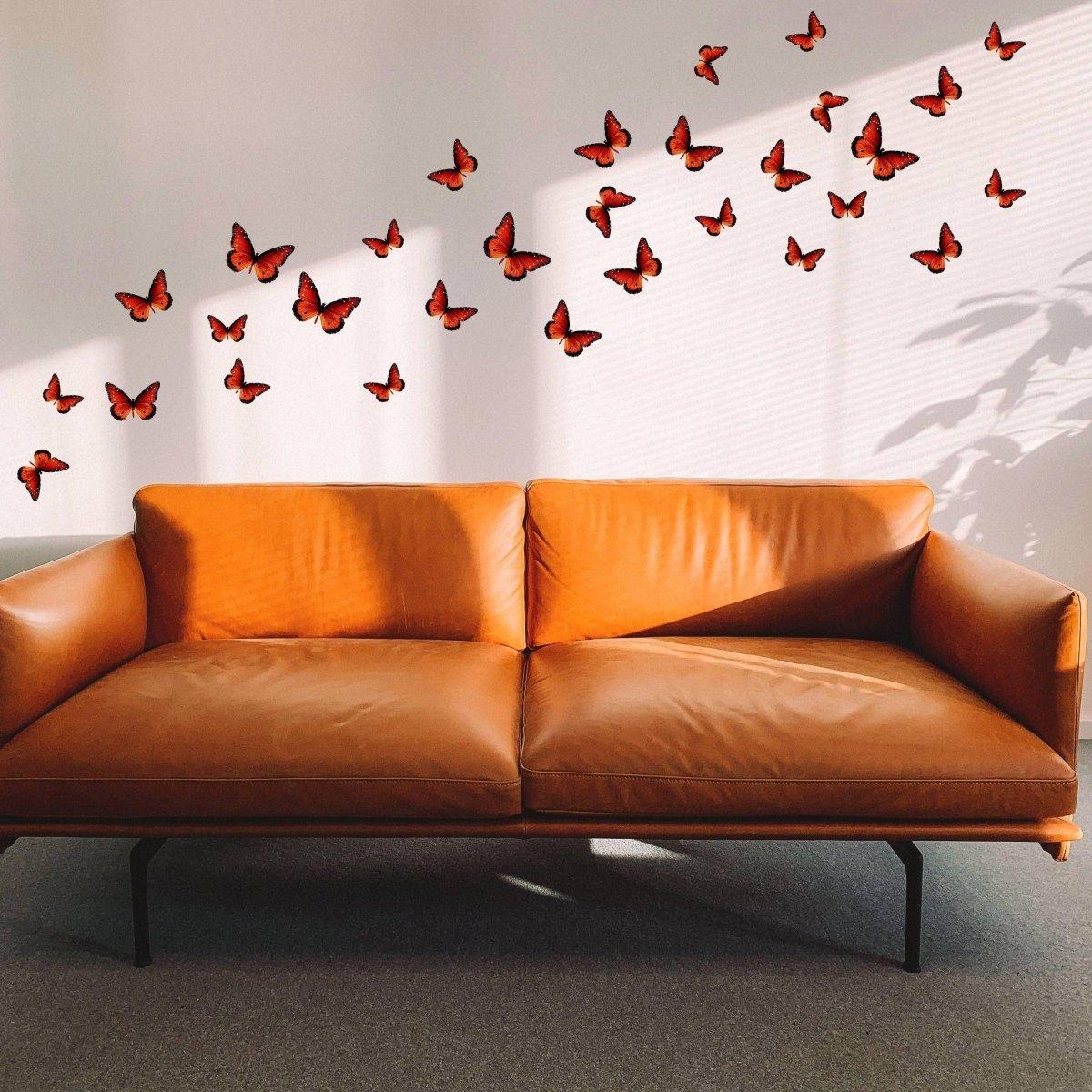 Stylish living room featuring a brown leather sofa and vibrant butterfly wall decor stickers for a magical touch.