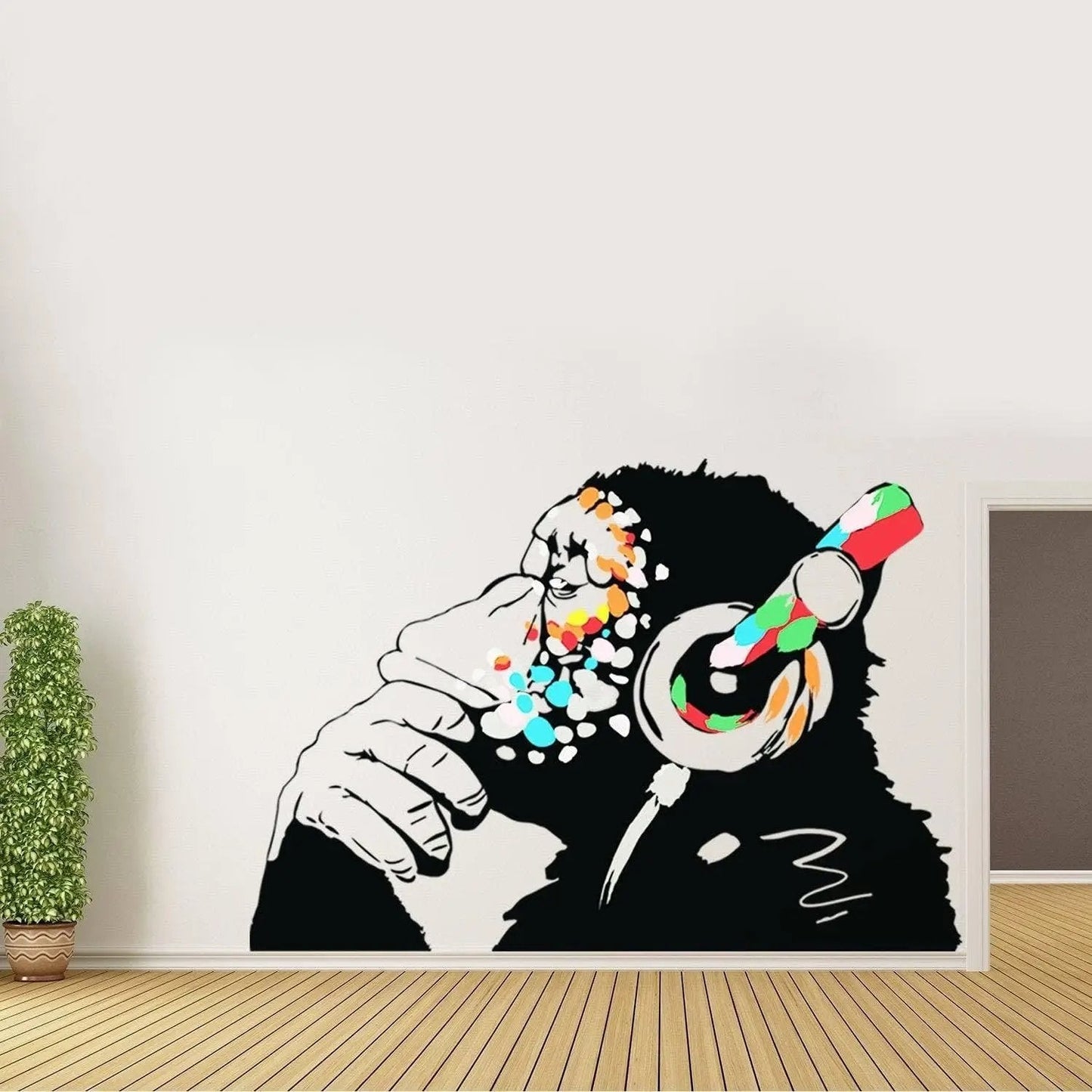 Banksy-inspired monkey wall sticker with headphones, showcasing vibrant colors and deep thought.