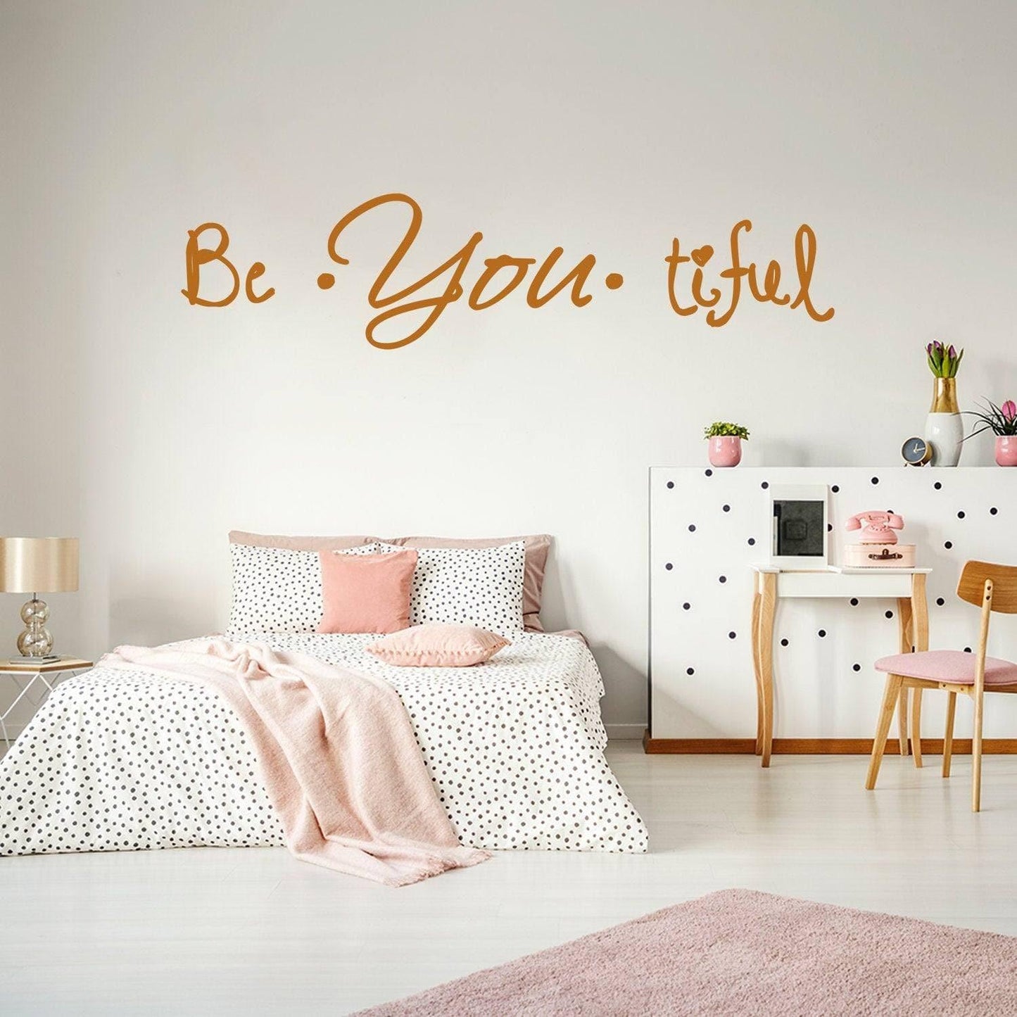 Inspirational 'Be You-tiful' vinyl wall decal in a stylish bedroom with polka dot decor and pastel accents.