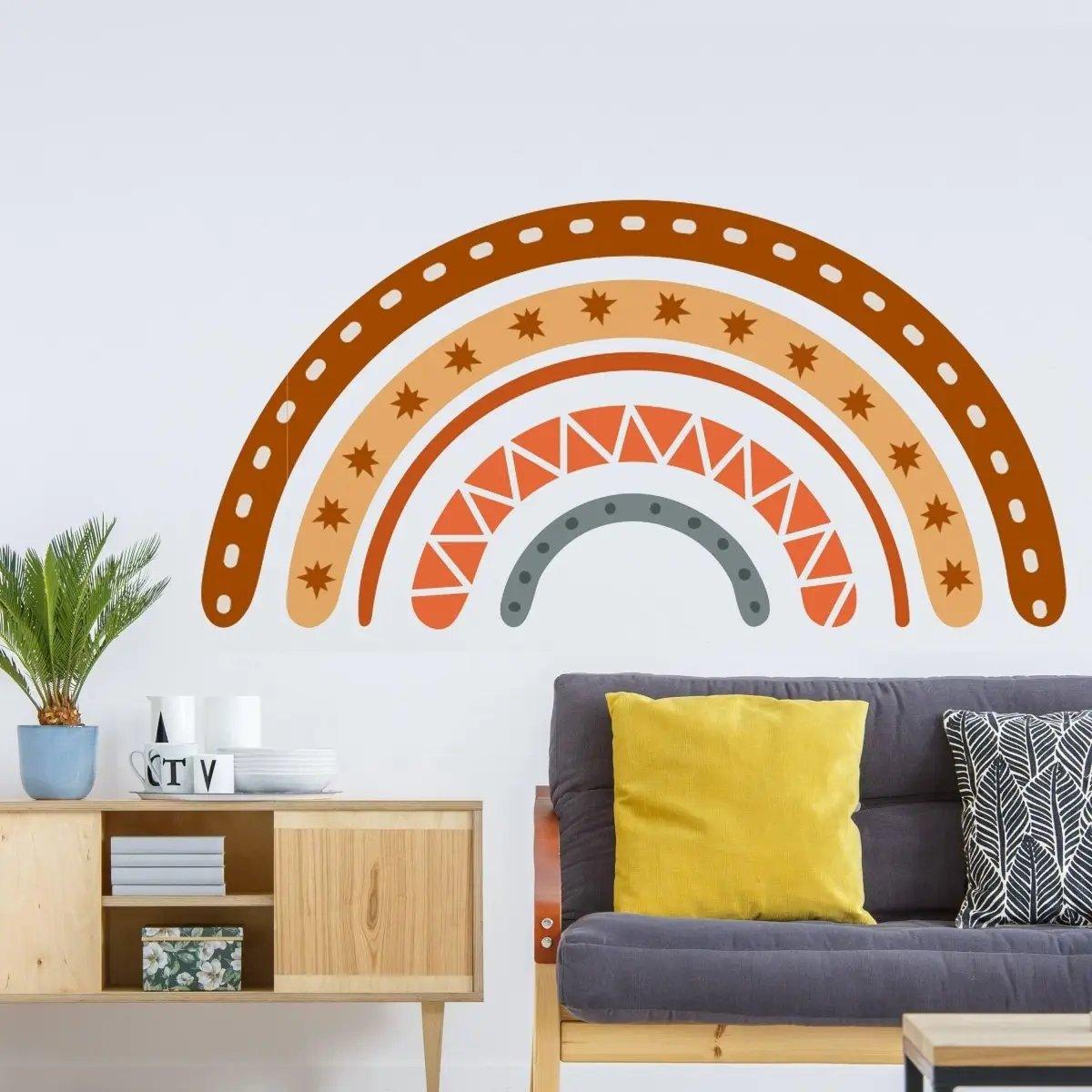 Boho rainbow wall decal in earthy tones, adding charm to a modern living room with colorful cushions.