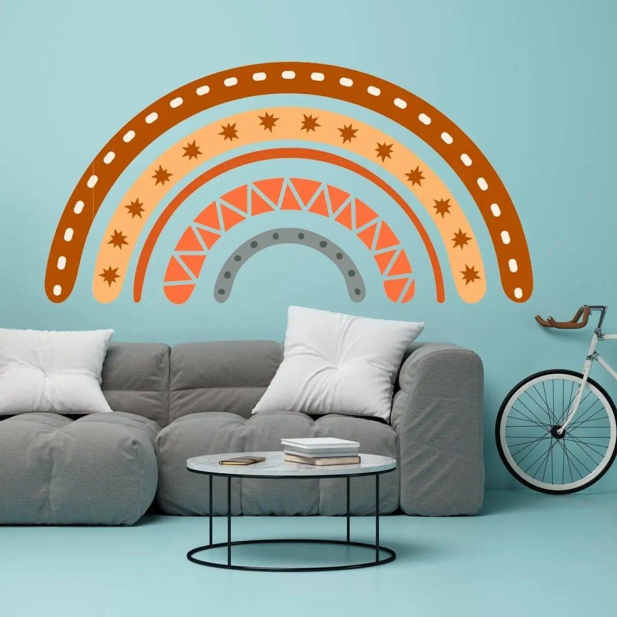 Boho chic multicolor rainbow wall decal above a stylish gray couch and coffee table in a modern room.