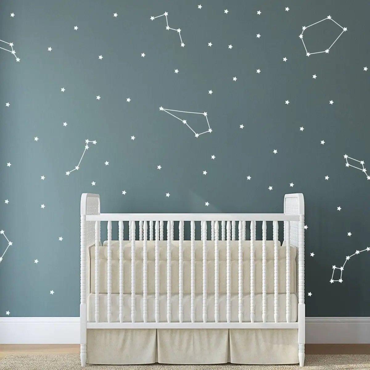 Celestial Dreams themed vinyl wall stickers displaying constellations above a crib in a nursery.