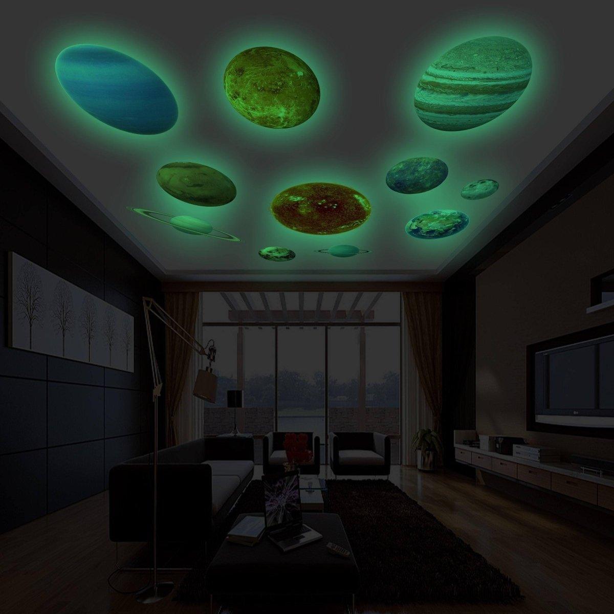 Glow in the dark planet wall stickers illuminating a modern living room ceiling, creating a celestial atmosphere.