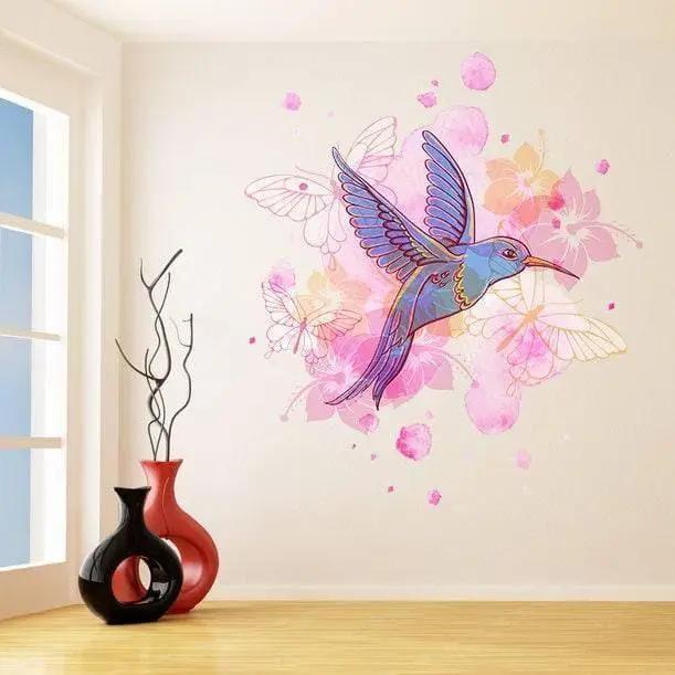 Colorful hummingbird wall vinyl sticker adding charm to modern home decor with pink flowers and butterflies.