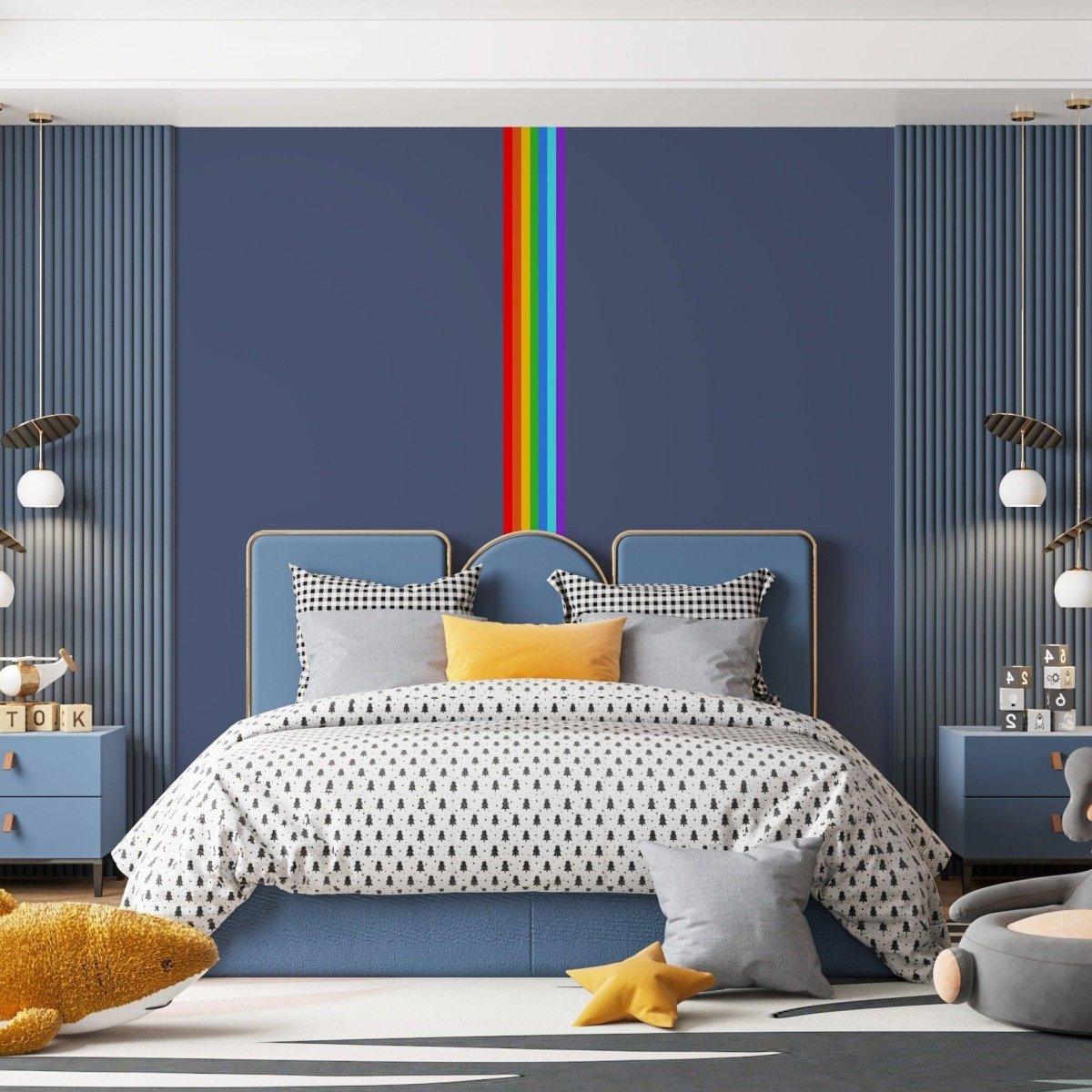 Colorful rainbow stripe wall decal in a stylish bedroom with a modern blue bed and cozy decor.