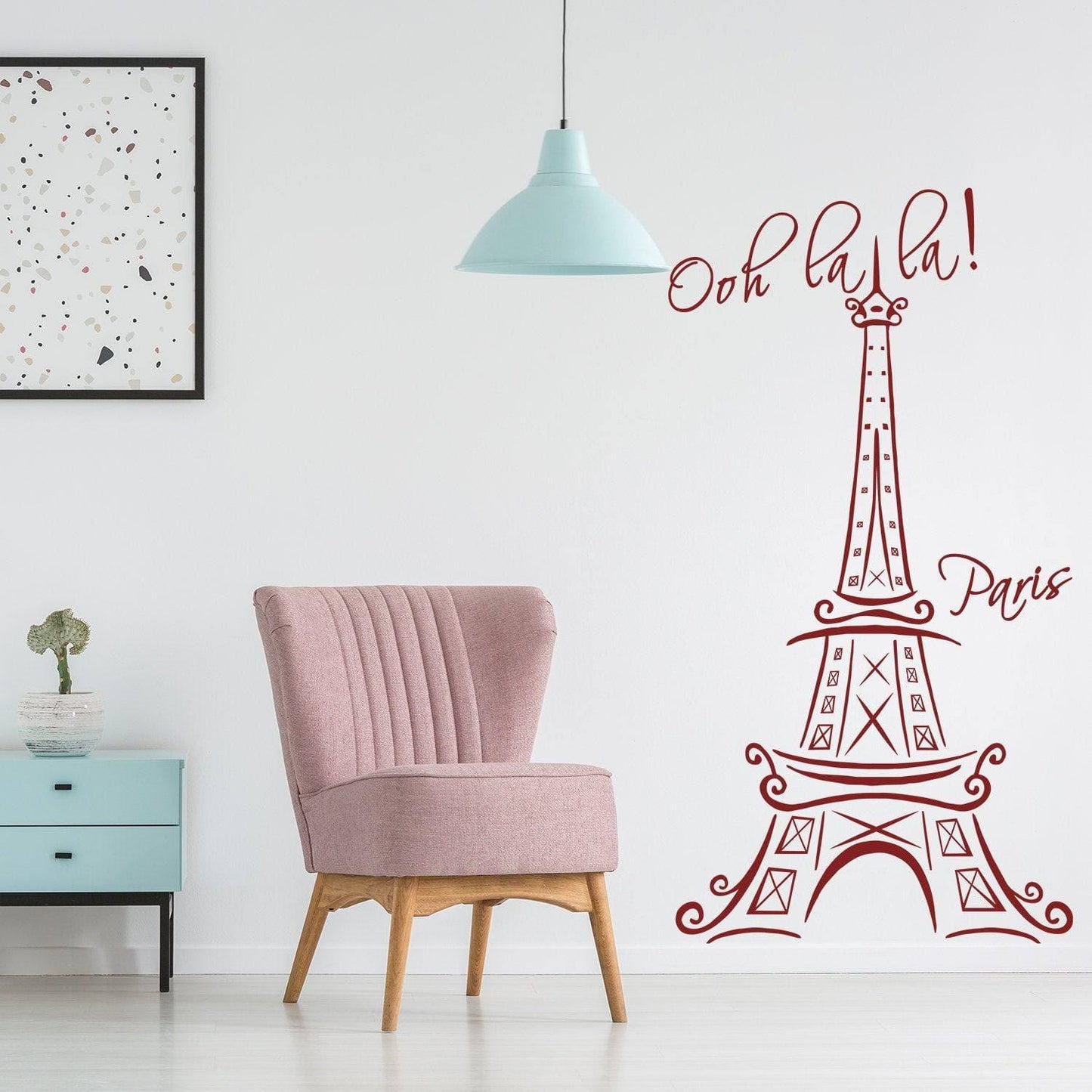 Eiffel Tower wall decal in a chic room with pink chair, adding a Parisian touch to indoor decor.