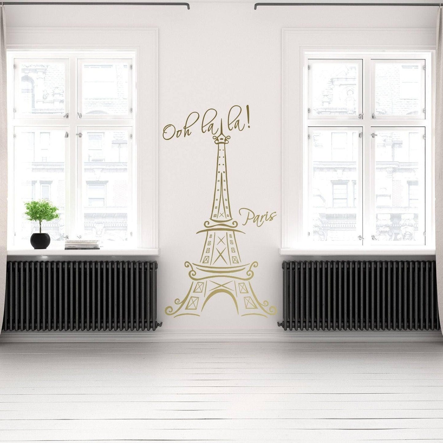 Eiffel Tower vinyl decal in a bright indoor setting, adding a Parisian touch with 'Ooh la la! Paris' text.
