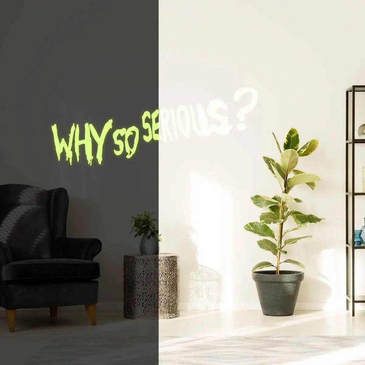 Glow in the dark 'Why So Serious?' Joker wall decal illuminating a stylish room decor with a plant.