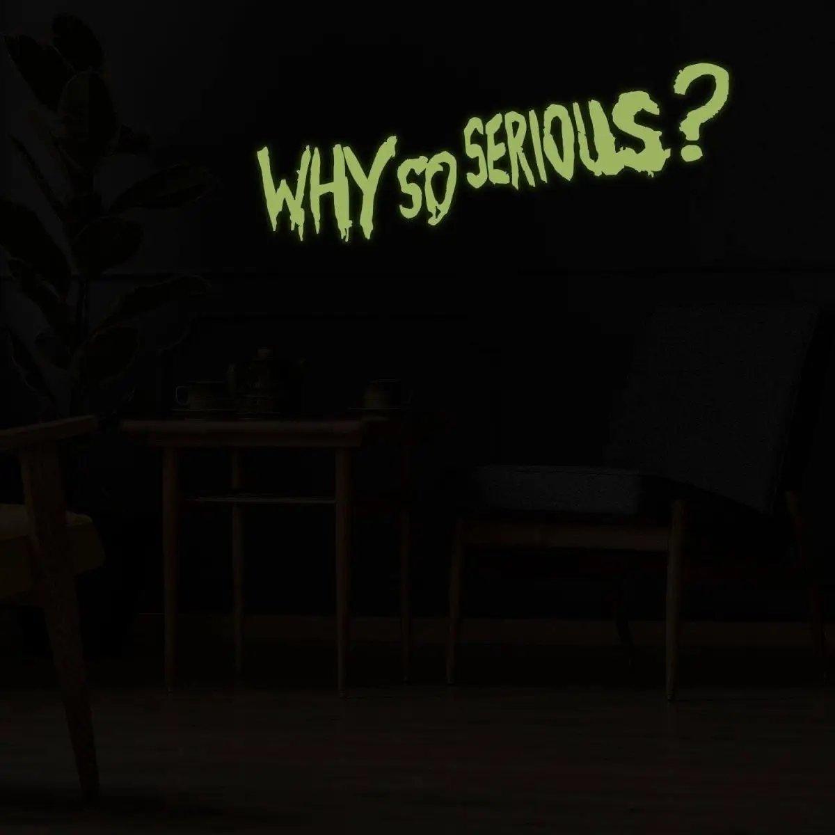 Joker wall art decal glowing in dark with the quote 'Why So Serious?' on black wall decor.