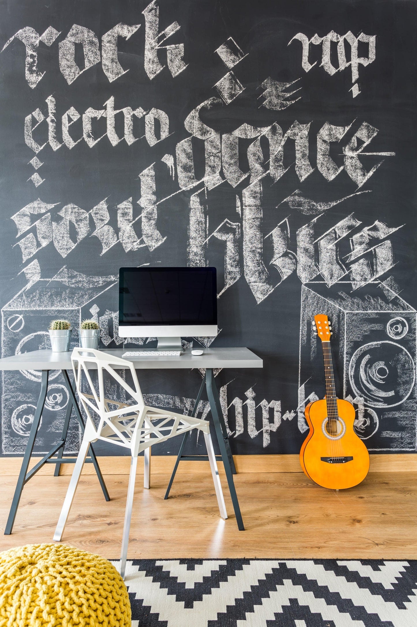 Stylish kids' workspace featuring a chalkboard wall decal with music-themed graphics and a modern desk setup.