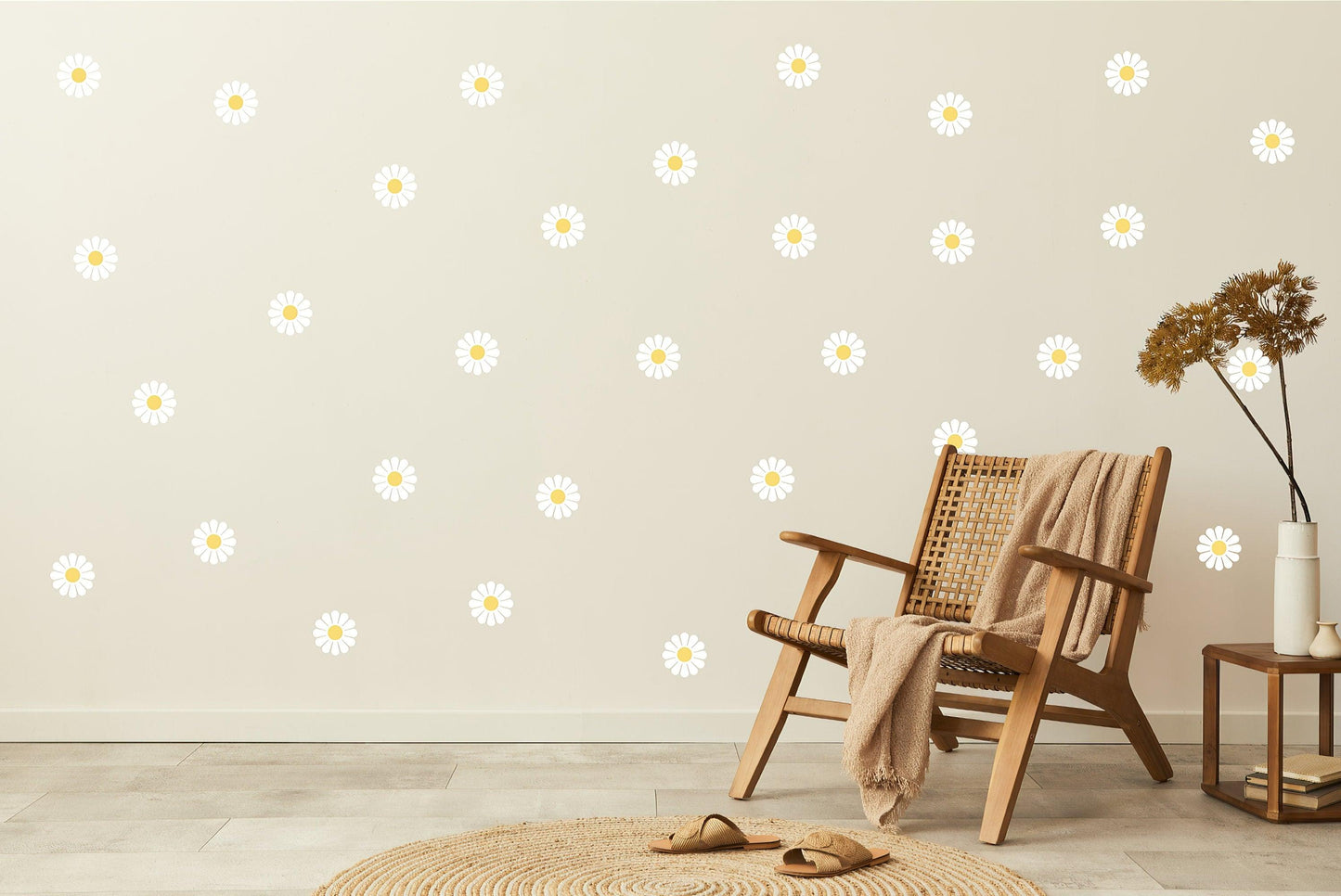 Elegant white daisy wall decals arranged on a light wall beside a cozy chair and natural decor.