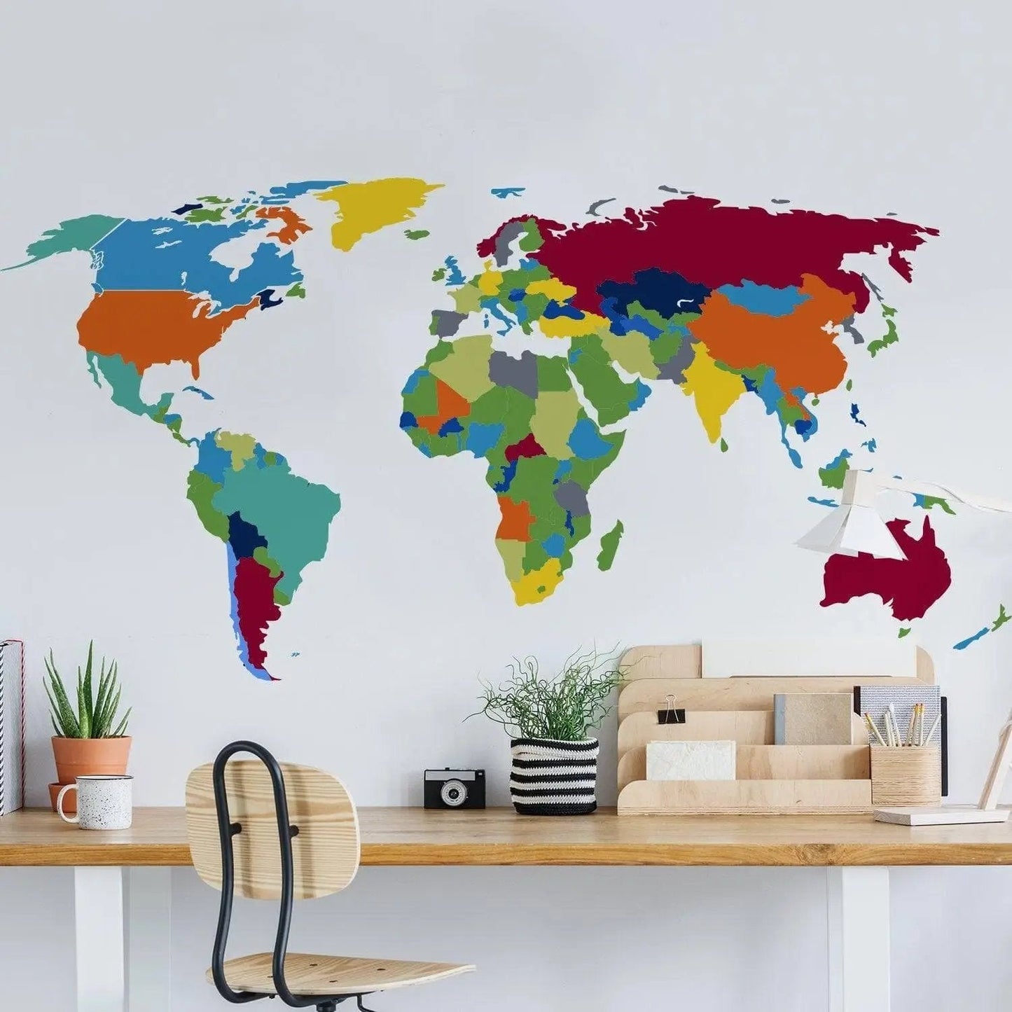 Colorful world map wall decal in a modern workspace, adding a touch of geography to home decor.