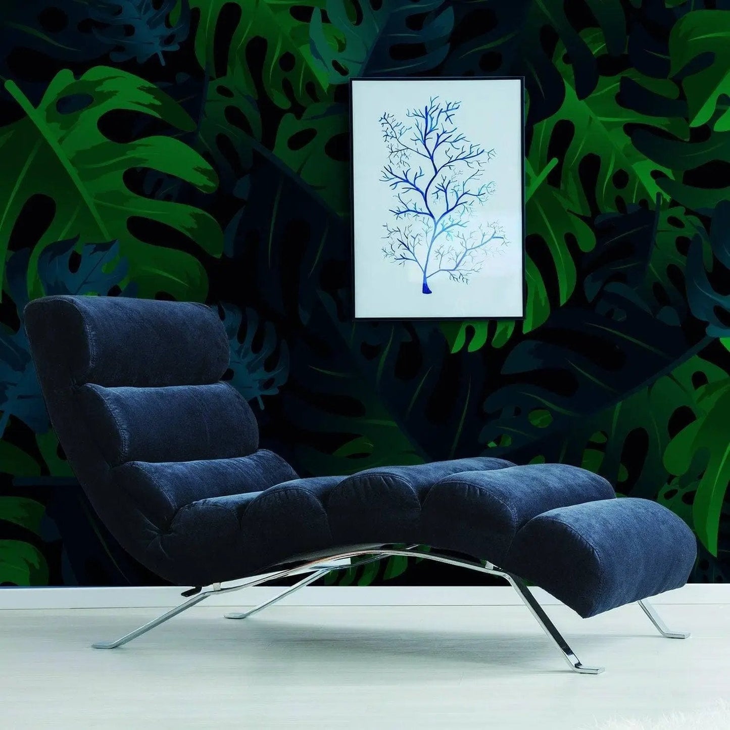 Modern lounge chair in front of tropical leaves peel and stick wallpaper and framed tree art for a stylish decor.
