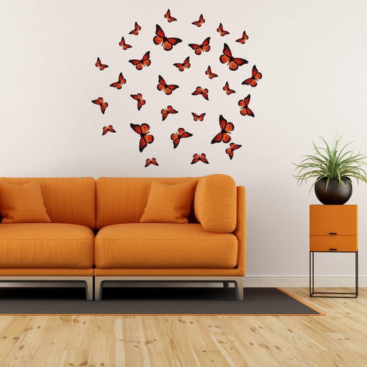 Beautiful butterfly wall decor stickers arranged above a cozy orange couch, adding a magical touch to the living room.