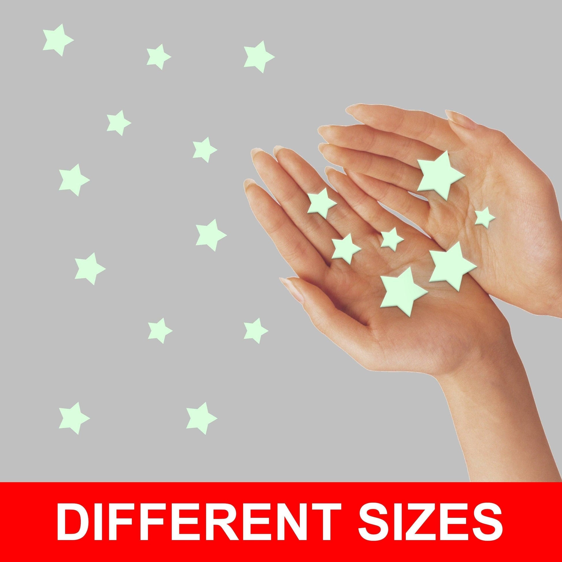 Hands holding glow in the dark stars in different sizes for decorating children's rooms.