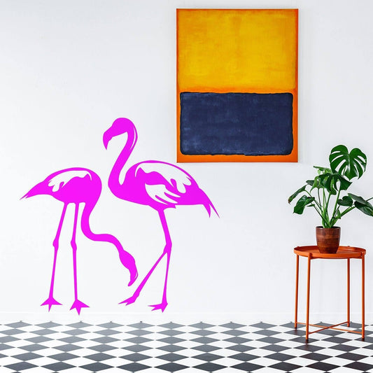 Pink flamingo wall decal in a stylish room featuring modern art and indoor plants.