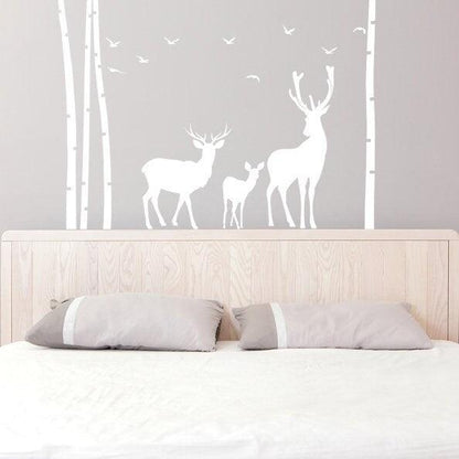 Deer and moose wall decal in a birch tree forest above a bed, perfect for nursery or kids room decor.