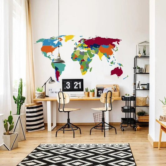 Vibrant world map wall sticker in modern workspace with desk and plants, ideal for geography lovers and decor.