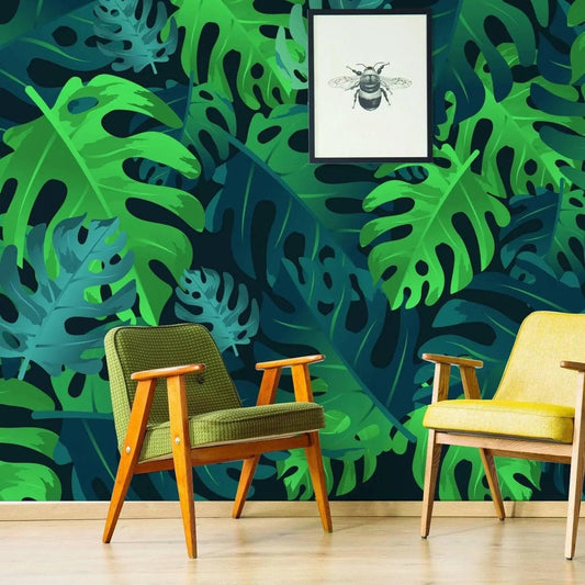 Tropical Paradise Peel and Stick Wallpaper with green leaf pattern, showcasing cozy chairs and framed bee art.
