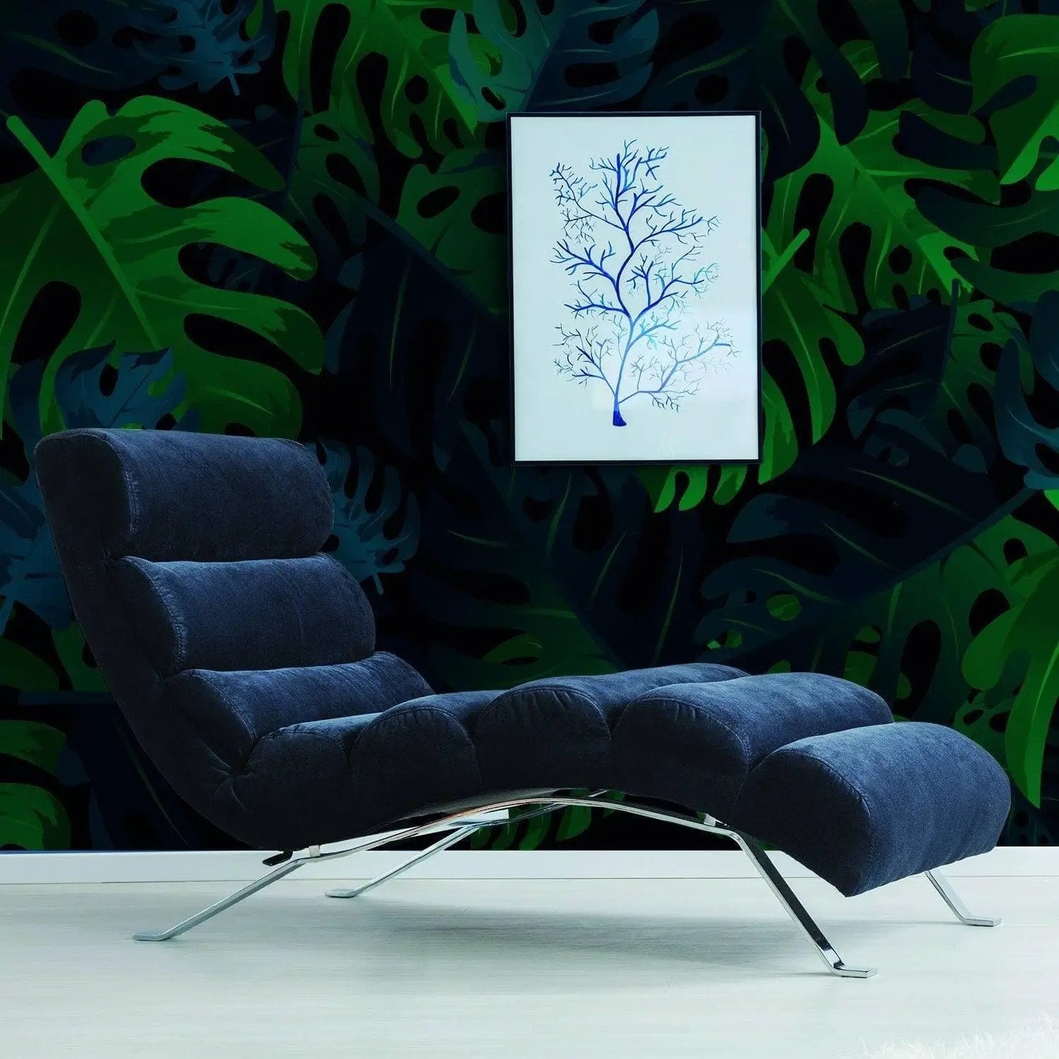 Modern lounge chair in front of tropical leaves peel and stick wallpaper and framed tree art for a stylish decor.