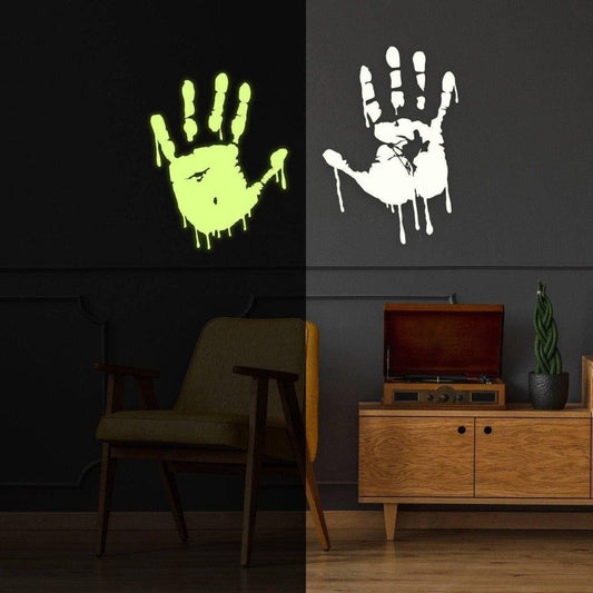 Glowing zombie blood wall decals on dark wall featuring glow-in-the-dark green and white handprints for spooky decor.