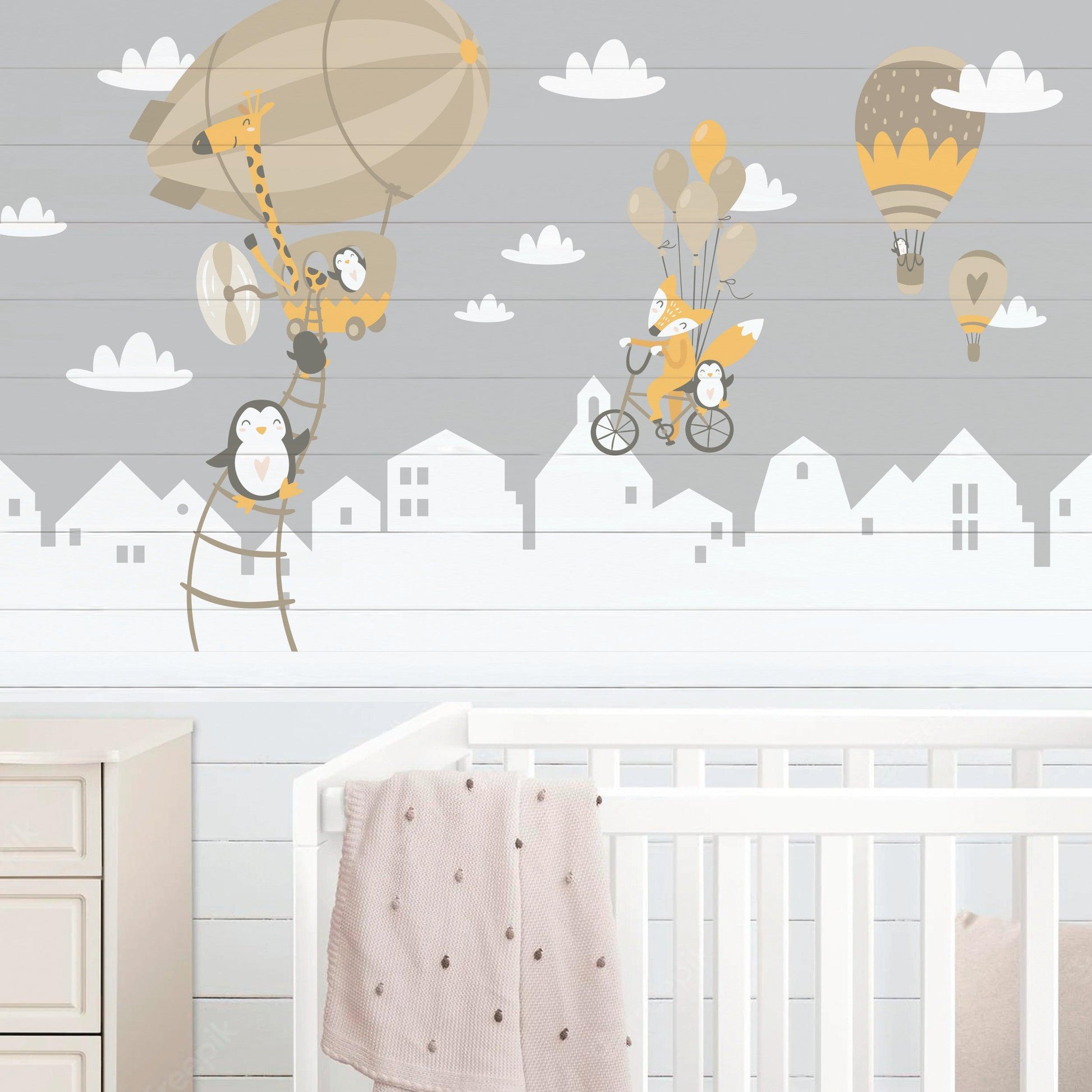 WhimsyLand wall decals featuring penguins, fox, and hot air balloons in a nursery setting.