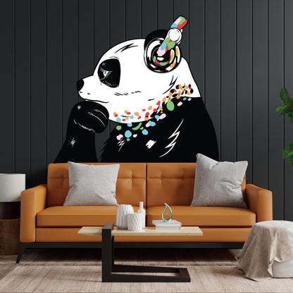 Banksy-inspired panda wall decal in a modern living room with orange sofa and decorative pillows.